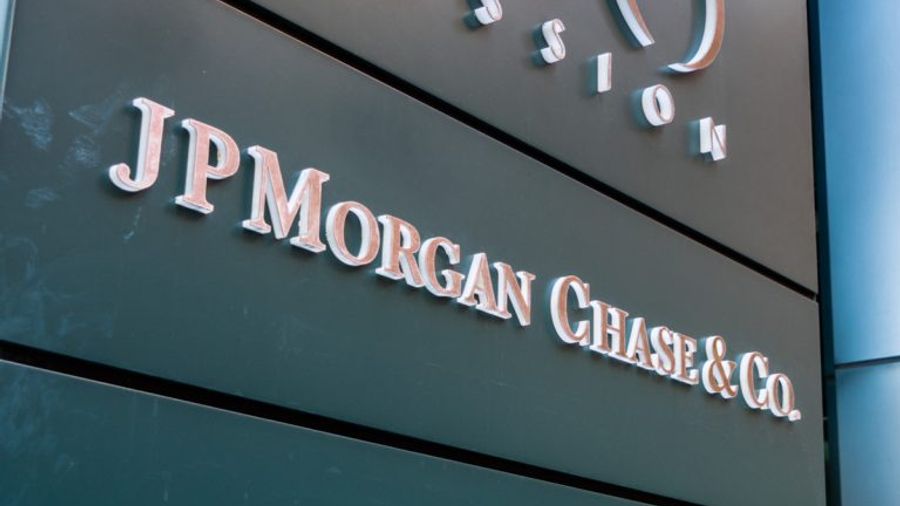 The web page is a news article from Bloomberg Technology that reports on JPMorgan’s expansion of its blockchain project, JPM Coin, to enable euro payments for corporate clients.